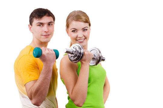 Couple exercising with dumbbells lifting weights