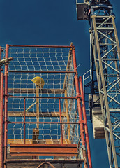 Protective yellow helmet on scaffolding