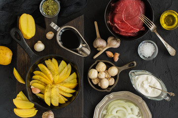 Healthy dinner ingredients over black stone table