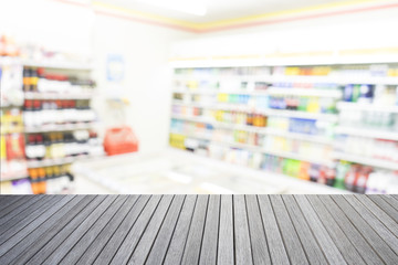 Empty top of wooden table and supermarket blur background