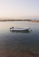 Lonely boat at sunset. Taken in the North-Western sector of the Bay of Gibraltar, in the municipalities of Los Barrios and Algeciras. Spain