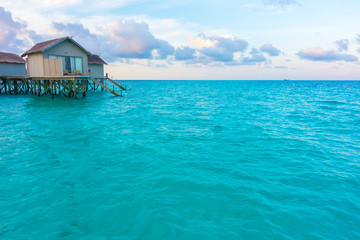Beautiful sunrise with  water villas  in tropical Maldives islan