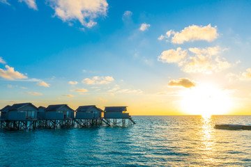 Beautiful sunset with  water villas  in tropical Maldives island