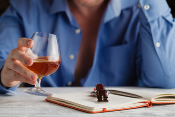 Businessman in formal dress relax with glass of cognac