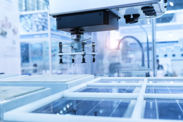 production of solar panels, Industrial robot working in factory,