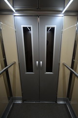 Interior view of an elevator facing the entrance doors