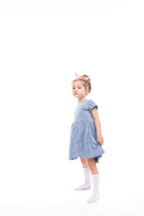 Little girl full length posing on a white.