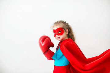 Superhero kid in boxing gloves Isolated on white background.