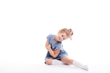 Closeup image of a pretty little girl sitting on the floor.