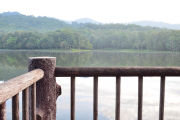 A view point from wooden balcony with lake and forest background in morning day,chet khot - pong kon sao nature study center,saraburi city,thailand.  © LittleGallery