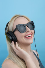 Young woman with headphones  listening to music and having fun a