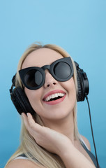 Young woman with headphones  listening to music and having fun a