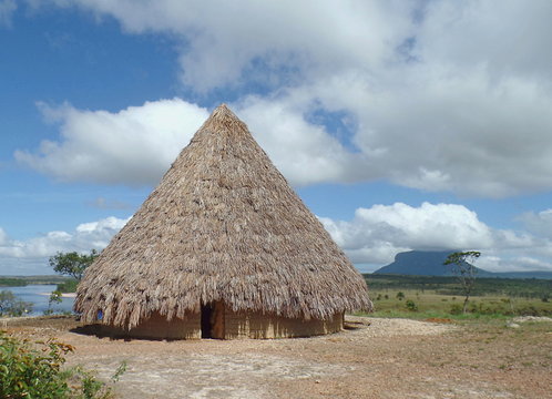 Native landscape / native home built with mud and straw on the coast of the river Carrao, in the Venezuelan Gran Sabana, Canaima National Park