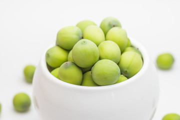 Fresh lotus seeds in vase and white background.