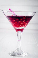 Pomegranate martini with pomegranate seeds in a glass