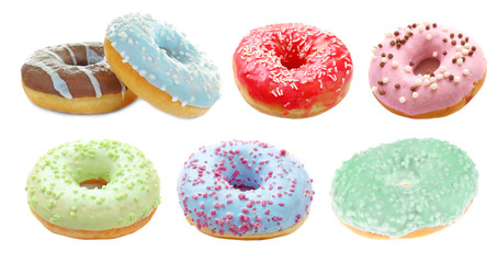 Fototapeta na wymiar Tasty donuts on white background