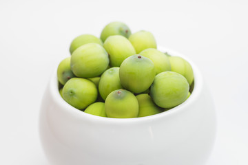 Fresh lotus seeds in vase and white background.