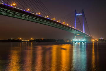 Vidyasagar bridge (Setu) on river Hooghly under night illumination, Kolkata India.