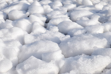 Lumps of snow and ice frazil on the surface of the freezing rive
