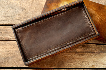 Fototapeta na wymiar Brown leather purse on wooden background