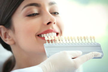 Dentist matching teeth colour in office