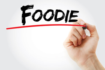 Hand writing Foodie with marker, concept background