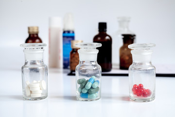 glass jars of pills - home first aid kit