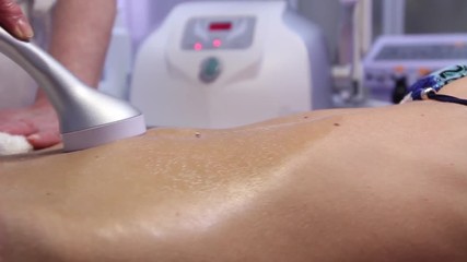Doctor makes the hardware massage woman belly