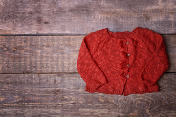 Warm red jacket on wooden background