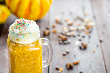 Pumpkin Smoothie with Whipped Cream on Top on Dark Brown Wooden Background, Copy Space for Text