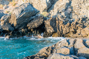 A view from the reef rocks of a mediterranean spanish beach (San Cristobal beach) during sunset at Almunecar, Granada, Spain