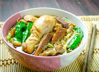 rice noodle soup with stewed chicken and vegetable in a bowl