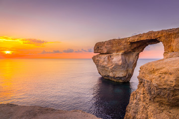 Panoramic View of Amazing Sunset over the Sea near Azure Window using as Wallpaper or Nature Background, Gozo, Malta - obrazy, fototapety, plakaty