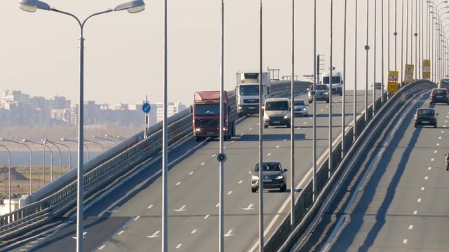 Many trucks and cars go over the bridge. Saint-Petersburg, Russia, 2016