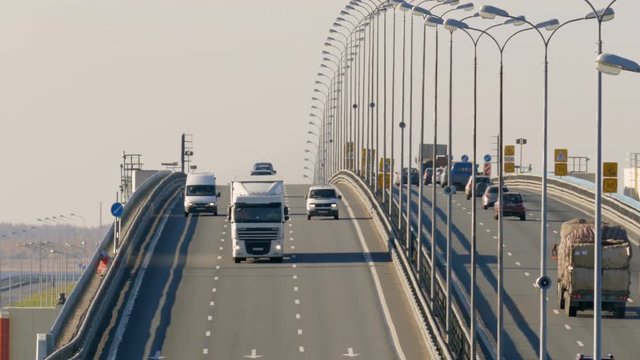 Many trucks and cars go over the bridge. Saint-Petersburg, Russia, 2016