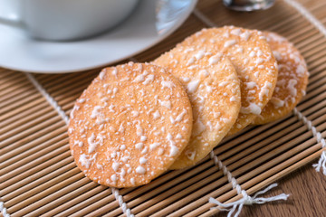 Black coffee in white cup and Crispy Rice Crackers with on woode