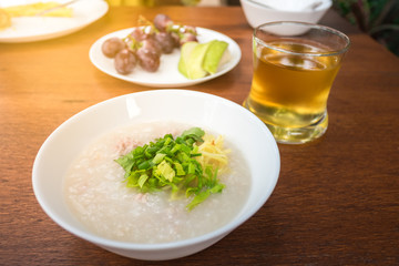 Pork porridge with ginger and coriander in bowl.
