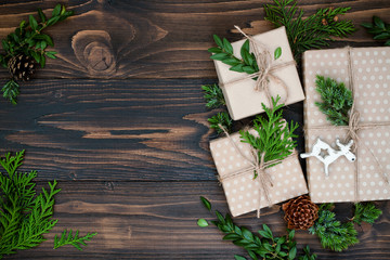Christmas background with hand crafted gifts, presents  on rustic wooden table. Christmas or New year DIY packing. Holiday decor concept. Overhead, flat lay, top view, copy space