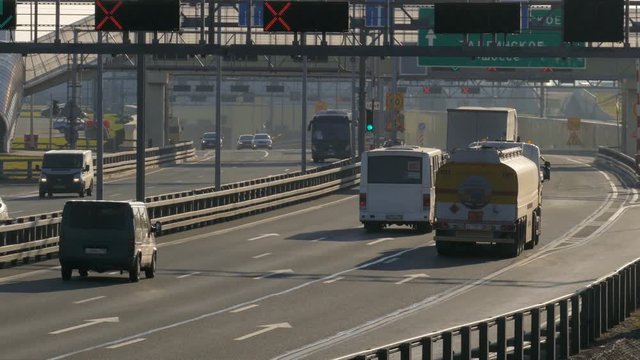 several trucks and cars driving on the highway at the sunset. Saint-Petersburg, Russia, 2016