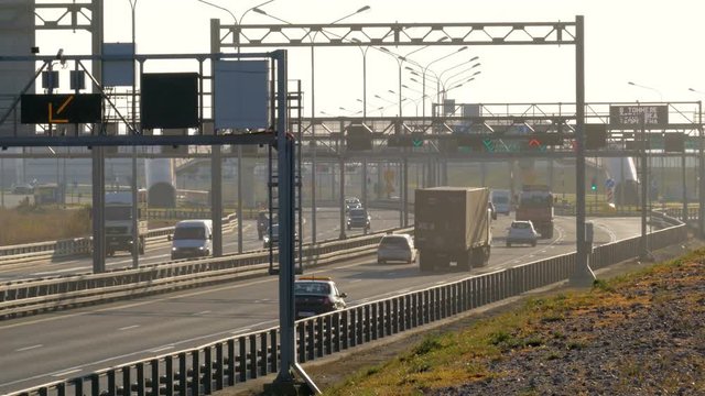 several trucks and cars driving on the highway at the sunset. Saint-Petersburg, Russia, 2016