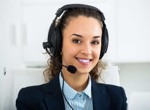 Call center operator talking with client and smiling
