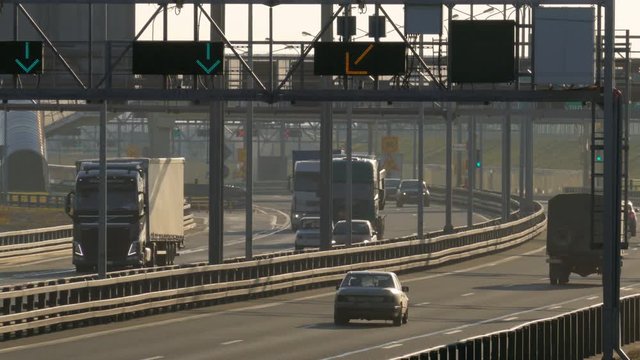 several trucks and cars driving on the highway at the sunset. Saint-Petersburg, Russia, 2016