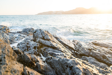 A view from the reef rocks of a mediterranean spanish beach (San Cristobal beach) during sunset at Almunecar, Granada, Spain