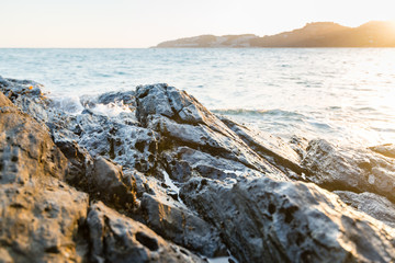 A view from the reef rocks of a mediterranean spanish beach (San Cristobal beach) during sunset at Almunecar, Granada, Spain