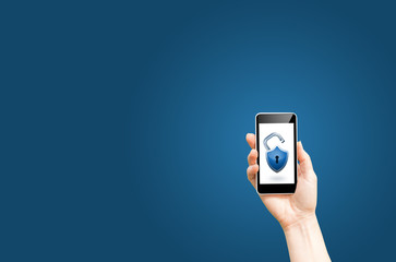 Holds smart phone with open lock on a blue background, security concept