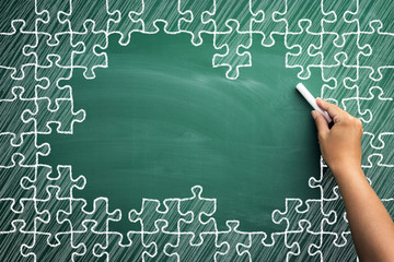 Puzzle pieces on chalkboard with empty space for text © Cherries