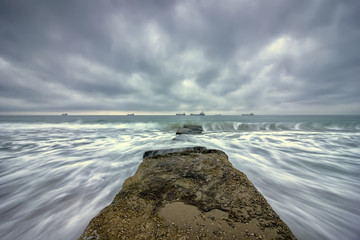 Beauty cloudy, long exposure seascape with slow shutter and waves flowing out.