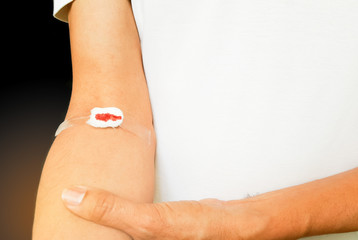 Bleeding cotton  bandage from blood check up wound black backgro
