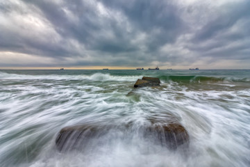 Beauty cloudy, long exposure seascape with slow shutter and waves flowing out.