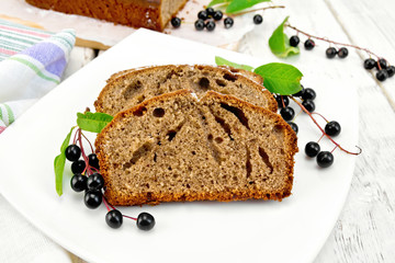 Fruitcake bird cherry in plate on board